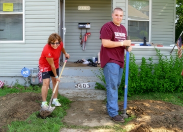 a couple of people digging in the dirt