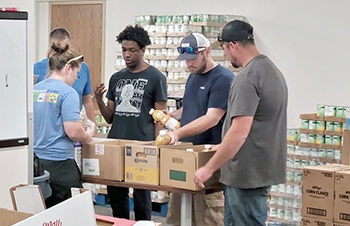 Connections-Good-Neighbor-House-pantry-assembly-line.jpg