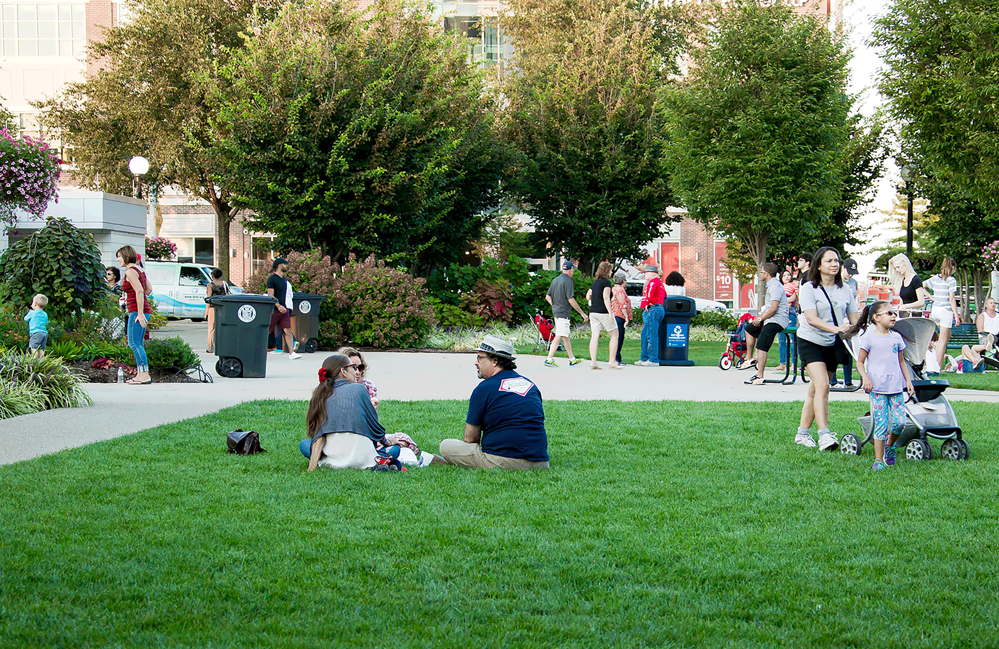 a group of people sitting on grass in a park