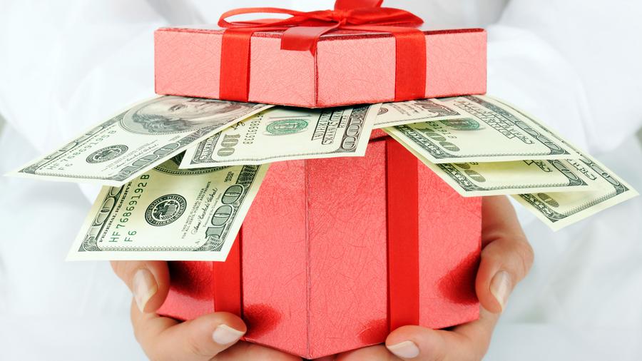red present box with money coming out of it